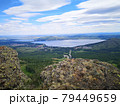 A large stone on the background of mountains with trees 79449659