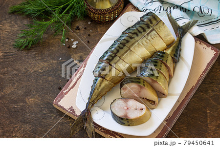 Mediterranean food. Seafood. Tasty Appetizing smoked mackerel with spices on dark rustic wooden table. Copy space. 79450641