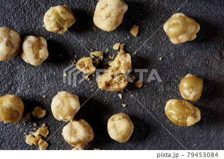 some crispy roasted peas on a dark gray surface some crispy roasted peas on a dark gray surface 79453084