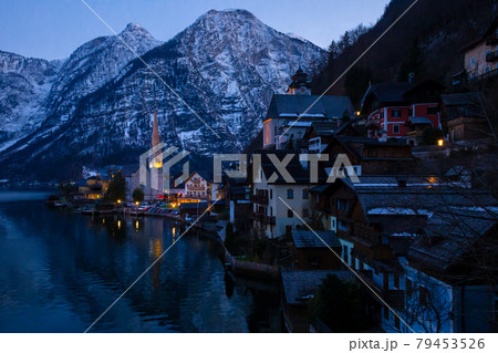 VIew of beautiful Hallstatt lake and famous church during late evening after sunset in early spring with mountain ranges VIew of beautiful Hallstatt lake and famous church during late evening after sunset in early spring with mountain ranges 79453526