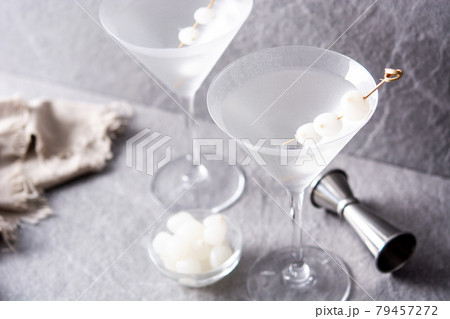 Gibson martini cocktail with onions . 79457272