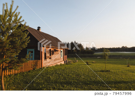 wooden european house in a picturesque countryside at sunset in summer wooden european house in a picturesque countryside at sunset in summer 79457996