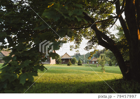 wooden european house in a picturesque countryside at sunset in summer wooden european house in a picturesque countryside at sunset in summer 79457997
