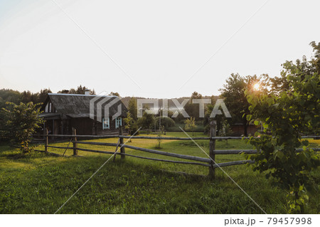 wooden european house in a picturesque countryside at sunset in summer wooden european house in a picturesque countryside at sunset in summer 79457998