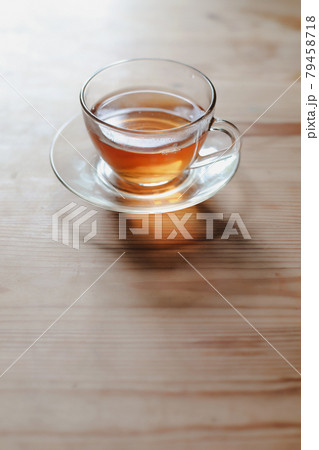 a glass cup of tea on a wooden table a glass cup of tea on a wooden table 79458718