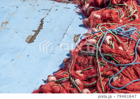 pile of red fishing nets on blue wooden background with copy space pile of red fishing nets on blue wooden background with copy space 79461647