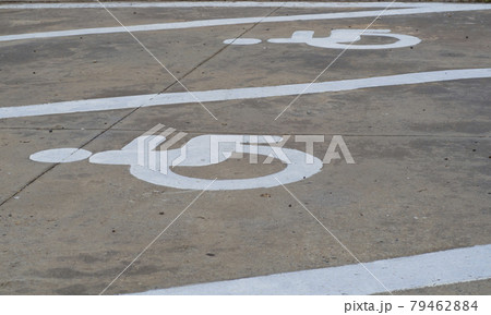 The symbol is a parking space for the disabled. Close-up of international markings for disabled parking spaces. 79462884