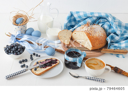 Easter breakfast or brunch table in blue style, embellished with Easter symbols,  traditional Czech Easter pastry Mazanec, Pomlazka and eggs. Easter breakfast or brunch table in blue style, embellished with Easter symbols,  traditional Czech Easter pastry Mazanec, Pomlazka and eggs. 79464605
