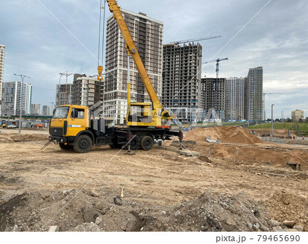 Workers engineers working at construction site and cranes on background of new building skyscrapers 79465690
