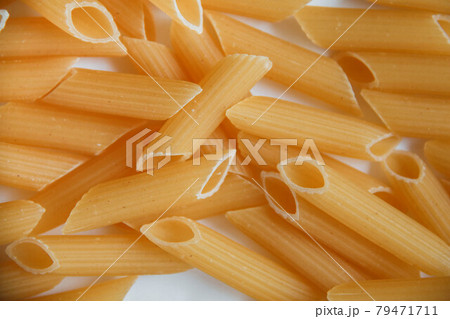 Raw macaroni on white. Dry noodles. Uncooked pasta. Raw macaroni on white. Dry noodles. Uncooked pasta. 79471711