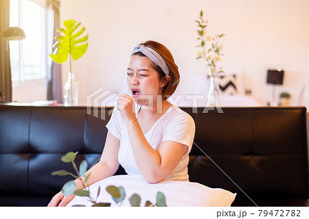 Asian woman coughing with sore throat,Women suffering with cough a lot at home 79472782