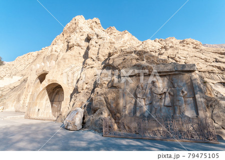 Carved into the rock, place with a several reliefs from the era of Sassanid Empire of Persia. Winter season, shortly after sunrise. 79475105