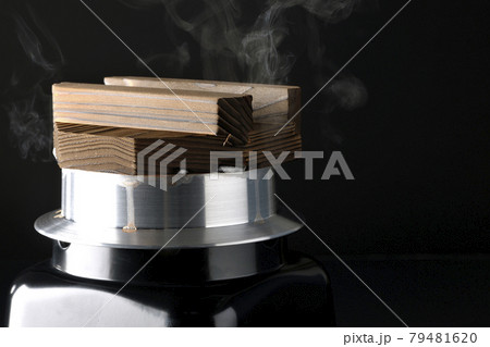 一合炊きのお釜でお米を炊く様子を黒背景で撮影 一合炊きのお釜でお米を炊く様子を黒背景で撮影 79481620