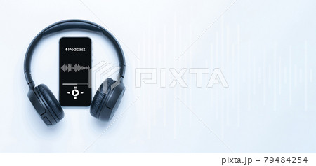 Podcast music. Mobile smartphone screen with podcast application, sound headphones. Audio voice with radio microphone on white background. Broadcast media music banner with copy space. Podcast music. Mobile smartphone screen with podcast application, sound headphones. Audio voice with radio microphone on white background. Broadcast media music banner with copy space. 79484254