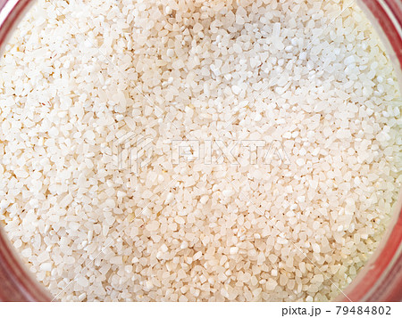 broken rice in pink glass jar 79484802