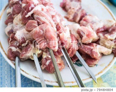 raw skewered shish kebabs from pork meat on plate 79484804