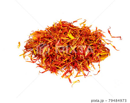 handful of dried safflower petals closeup on white 79484973