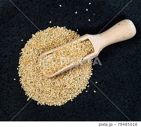 top view of scoop on foxtail millet seeds on black 79485016