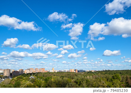 blue sky with many white clouds over park and city 79485230