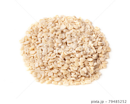pile of raw split black gram beans on white pile of raw split black gram beans on white 79485252
