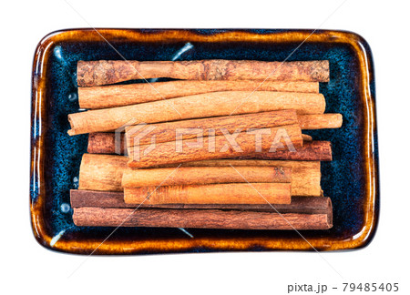 heap of chinese cinnamon (Cassia) in bowl cutout heap of chinese cinnamon (Cassia) in bowl cutout 79485405
