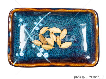 several dried Cardamom pods in bowl cutout several dried Cardamom pods in bowl cutout 79485406