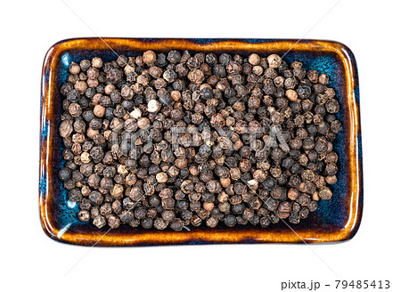 view of black pepper peppercorns in bowl cutout 79485413