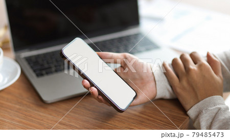 Cropped shot of businessman holding mobile phone with blank screen 79485473