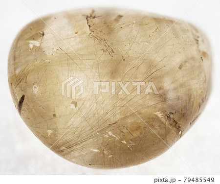 polished Rutilated quartz gemstone on white 79485549