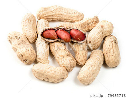 whole and unpeeled peanuts closeup on white 79485718