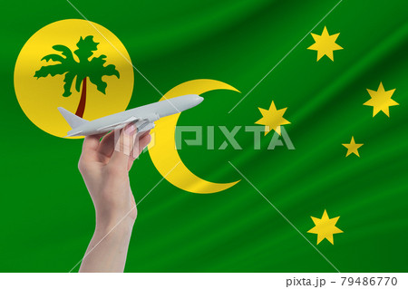 Airplane in hand with national flag of Cocos Islands. Travel to Cocos Islands Airplane in hand with national flag of Cocos Islands. Travel to Cocos Islands 79486770