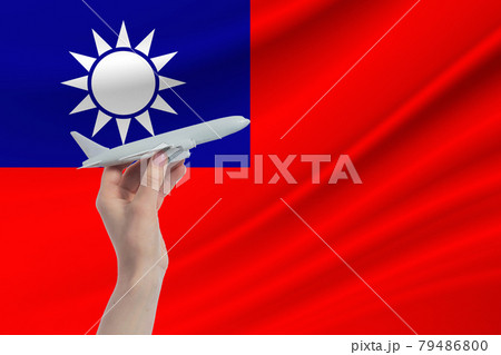 Airplane in hand with national flag of Republic of China. Travel to Republic of China 79486800