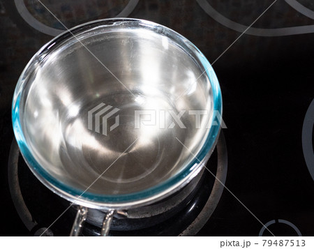 saucepot of water and glass bowl in it on stove saucepot of water and glass bowl in it on stove 79487513