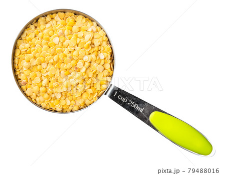 split yellow lentils in measuring cup cutout 79488016