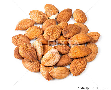 pile of of apricot kernels closeup on white 79488055