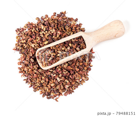 top view of scoop on pile of pink sichuan pepper 79488151