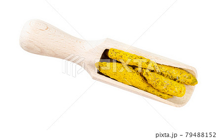 dried roots of Turmeric in wooden scoop cutout dried roots of Turmeric in wooden scoop cutout 79488152
