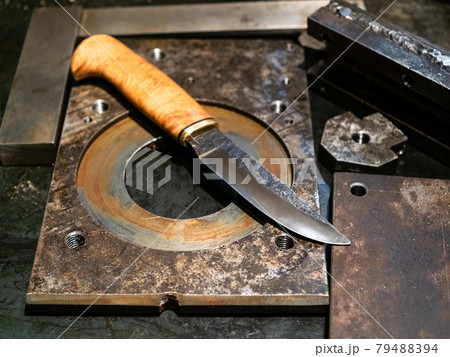 forged knife on metal workbench 79488394