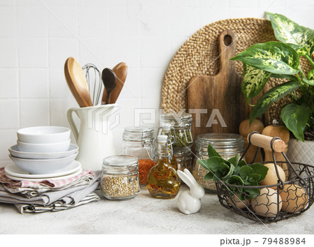 Kitchen utensils, tools and dishware on on the background white tile wall. Kitchen utensils, tools and dishware on on the background white tile wall. 79488984