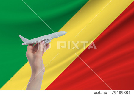 Airplane in hand with national flag of Republic of the Congo Travel to Republic of the Congo 79489801