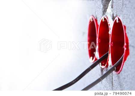 Socket boxes with wires in the wall. Cable routing background. Installation of new electrical wiring. 79490074