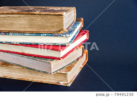 Stack of old books on dark background Stack of old books on dark background 79491230