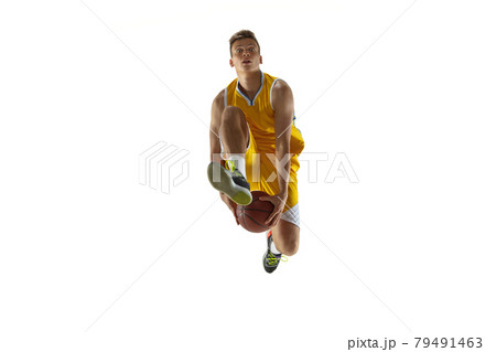 One young man, basketball player with a ball training isolated on white studio background. Advertising concept. Fit Caucasian athlete jumping with ball. 79491463