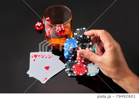 Casino chips, playing cards, glass of whiskey and dices on dark reflective background 79492601