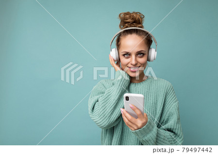 Photo shot of beautiful joyful smiling young female person wearing stylish casual outfit isolated 79497442