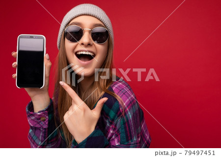 Closeup photo of attractive smiling positive young blonde woman wearing stylish purple shirt and 79497451