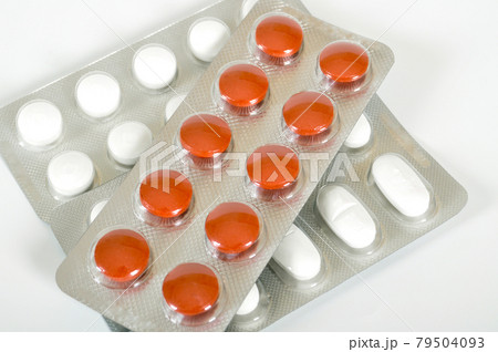 White and orange pills packed and used in healthy environment White and orange pills packed and used in healthy environment 79504093
