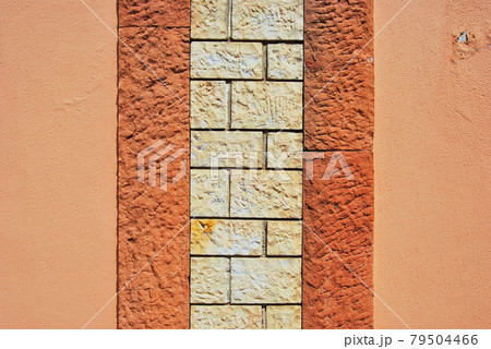 Sturdy yellow beige and red cut stone wall, seamless lined up 79504466