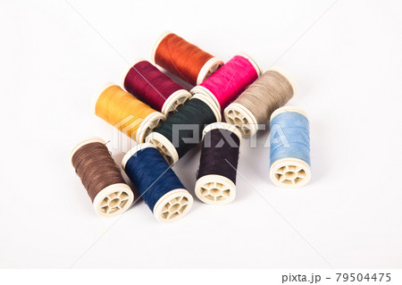 Spools and bobbins of thread for multicolor sewing, isolated on white background Spools and bobbins of thread for multicolor sewing, isolated on white background 79504475