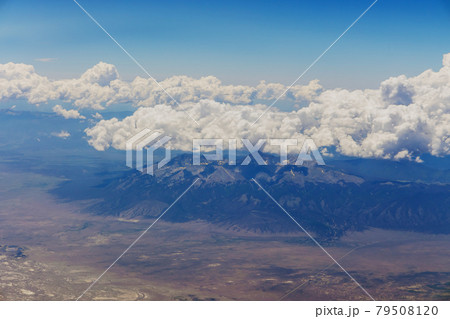 The view from the plane of fluffy clouds in mountains from an airplane, Arizona USA 79508120